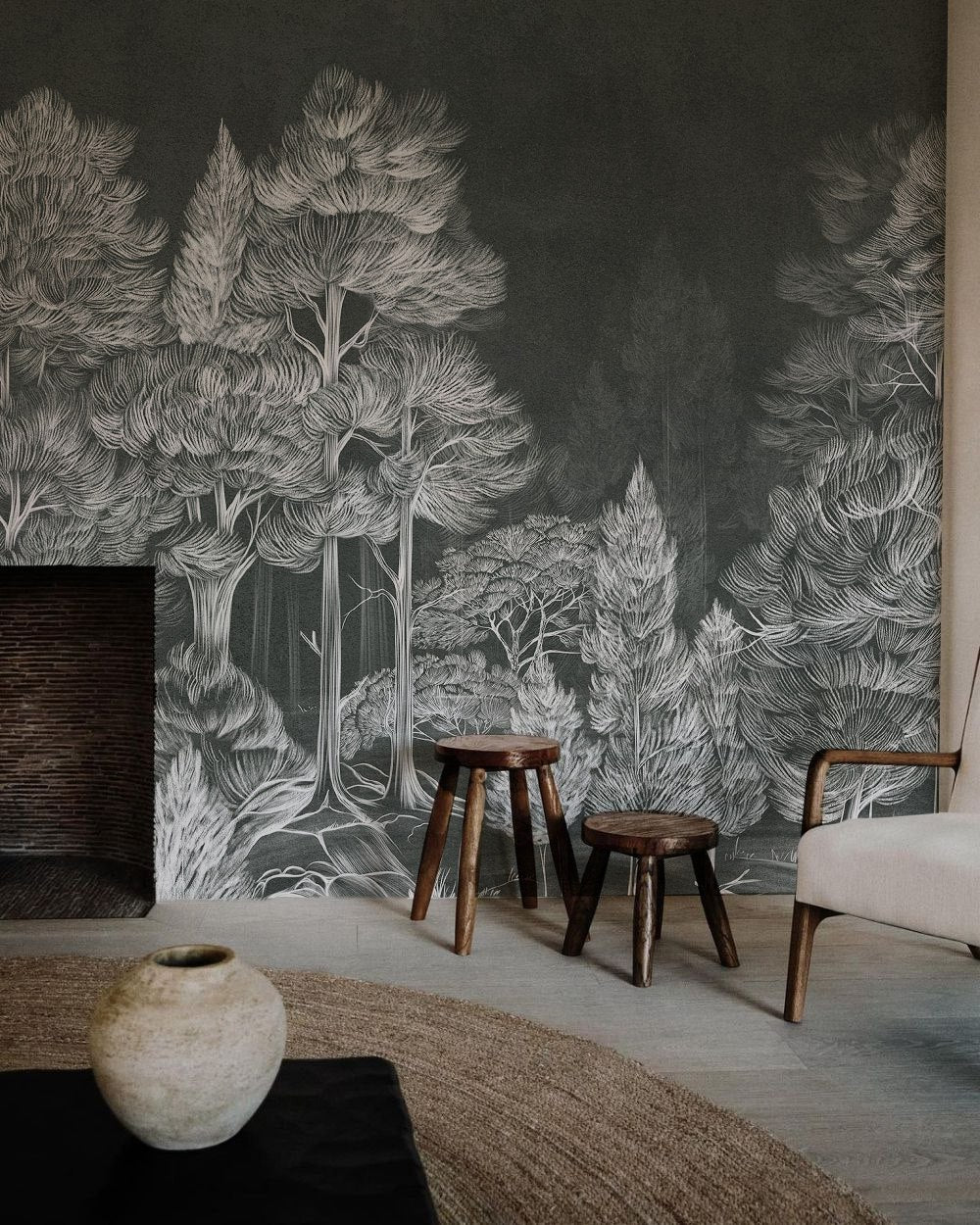 Room interior with a forest mural on the wall, wooden stool, and vase.