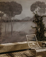 Outdoor setting with a bench and chair against a scenic wall mural.