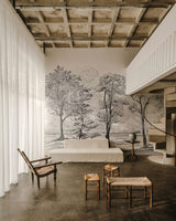 Modern interior with a large wall mural of trees, white sofa, and wooden furniture.