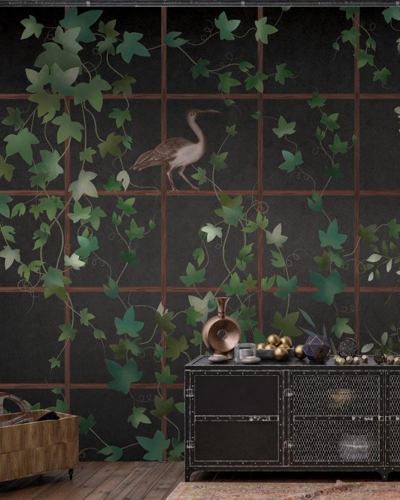 Decorative wall with green leaf patterns and black wallpaper background and a black console table with decorative items.