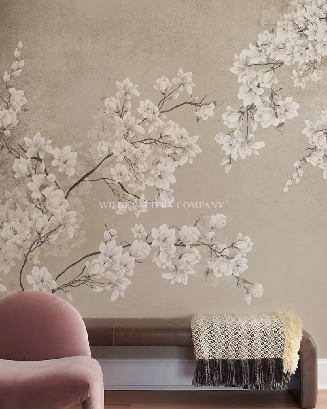 Floral wall mural a beige wall with a pink chair and brown bench.