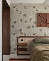 Bedroom with a vintage floral wallpaper for walls, wooden headboard, and striped rug.