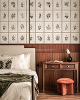 Bedroom with floral wallpaper, wooden desk, and decorative items.