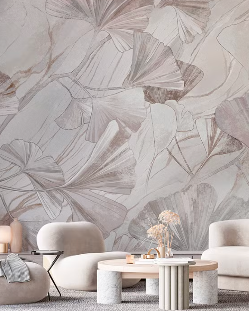 Modern living room with abstract leaf-patterned wallpaper and neutral furniture.