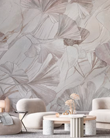 Modern living room with abstract leaf-patterned wallpaper and neutral furniture.