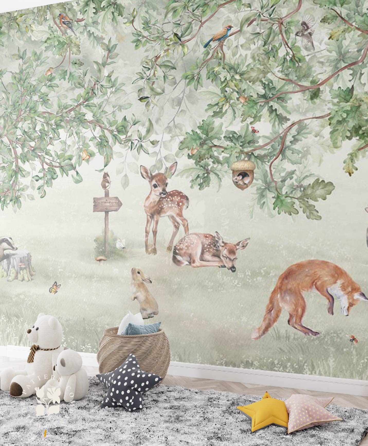 Children's room with forest-themed wallpaper featuring deer, fox, and birds, with toys on the floor.